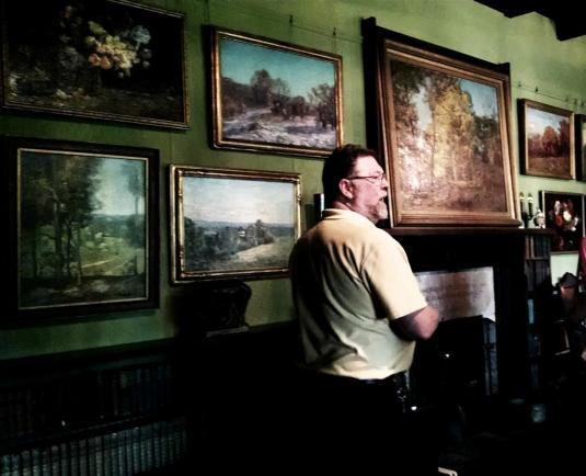 T.C. Steele's paintings grace the wall of his front parlor at his home near Nashville, Indiana.